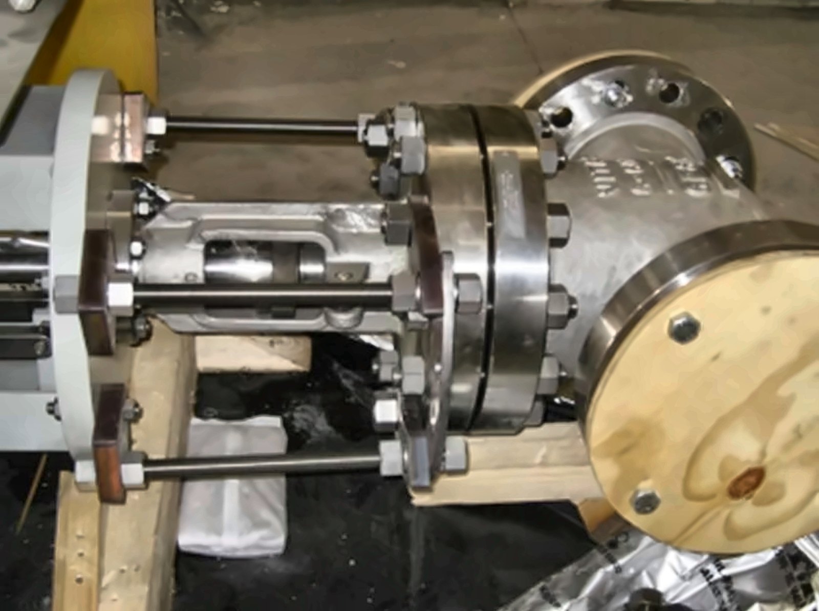 Studs and nuts on a gate valve test assembly